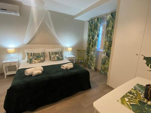 a bedroom with a bed with two pillows on it at Quinta das Amendoeiras in Albufeira