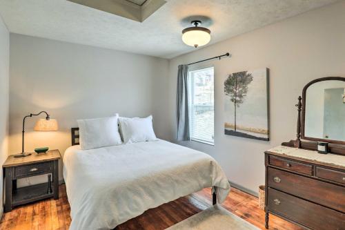 a bedroom with a bed and a dresser and a mirror at Cozy Omaha Vacation Rental 6 Miles to Downtown! in Omaha