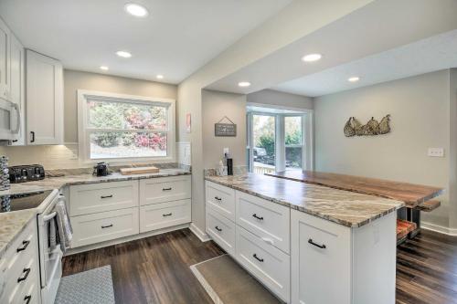 a kitchen with white cabinets and a counter top at Deck and Mtn Views Fain Chalet in Kingsport in Kingsport