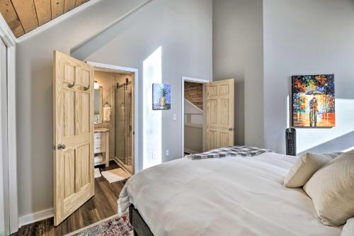 a bedroom with a white bed and a bathroom at Deck and Mtn Views Fain Chalet in Kingsport in Kingsport