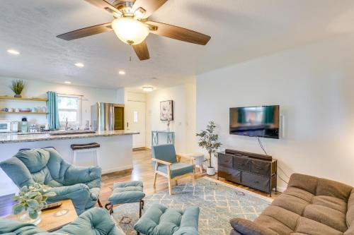 a living room with blue furniture and a ceiling fan at 2 Mi to Town and Beach! Lovely Kailua-Kona Home in Kailua-Kona