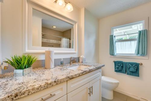 a bathroom with a sink and a toilet and a mirror at Lovely Kailua-Kona Home about 2 Mi to Town and Beach! in Kailua-Kona