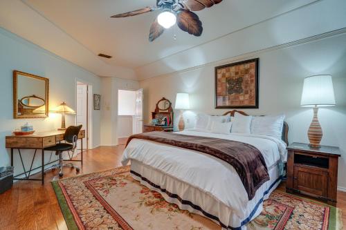 a bedroom with a bed with a ceiling fan and a desk at Spacious San Antonio Home with Patio and Grill! in San Antonio