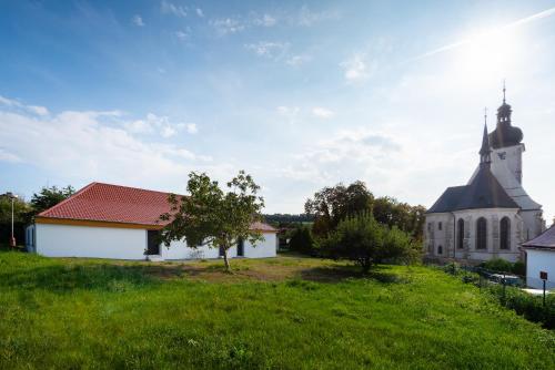 an old church on a hill with a green field at Kutnohorská vyhlídka in Kutná Hora