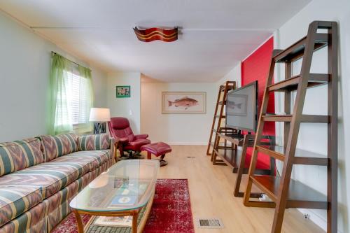 a living room with a couch and a tv at Fire Pit and Boat Dock Peaceful Dunnellon Cabin! in Dunnellon
