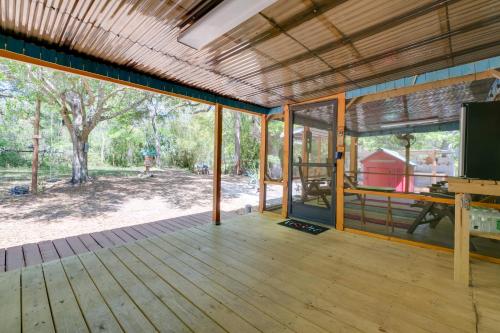 a large screened porch with a view of a park at Fire Pit and Boat Dock Peaceful Dunnellon Cabin! in Dunnellon