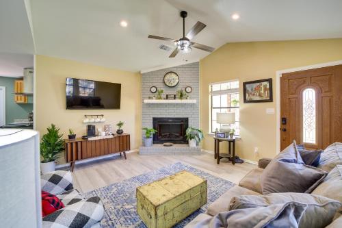 a living room with a couch and a fireplace at Barling Vacation Rental Fenced-In Yard with Hot Tub in Barling