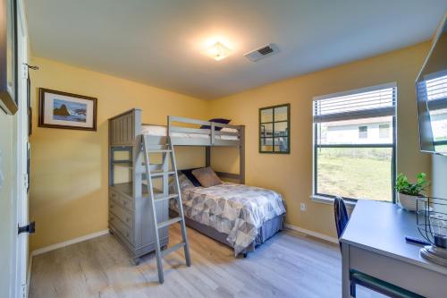a bedroom with a bunk bed and a desk at Barling Vacation Rental Fenced-In Yard with Hot Tub in Barling