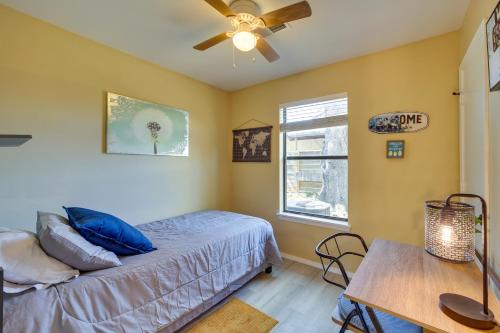 a bedroom with a bed and a table and a window at Barling Vacation Rental Fenced-In Yard with Hot Tub in Barling