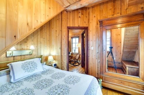 a bedroom with a bed in a wooden wall at Blue Sky Cabin in Sequim with Private Hot Tub! in Sequim