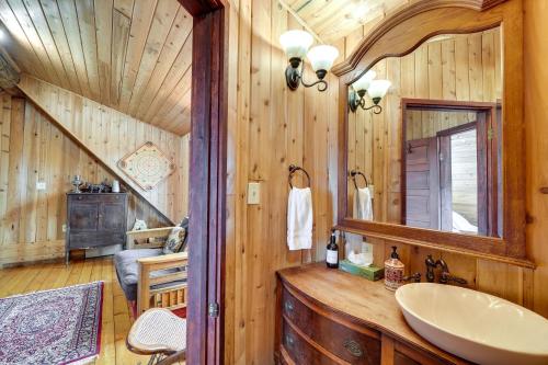 a bathroom with a sink in a log cabin at Blue Sky Cabin in Sequim with Private Hot Tub! in Sequim
