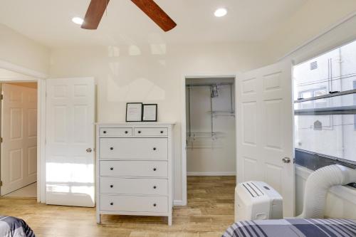 a bedroom with a white dresser and a closet at Sunny California Retreat Near Knotts Berry Farm! in Long Beach