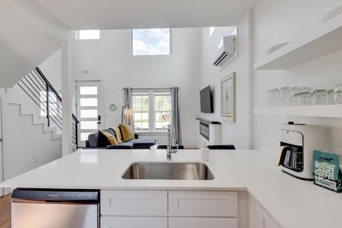 a white kitchen with a sink and a counter at Pet-Friendly Bowie Studio with Deck! in Bowie