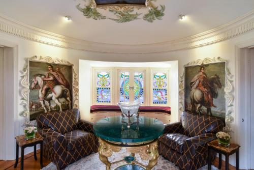 a living room with a table and two chairs at The Villa Casa Casuarina in Miami Beach