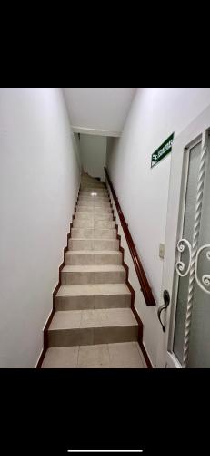 a long staircase in a building with a sign on it at Apartamento101 in Roldanillo