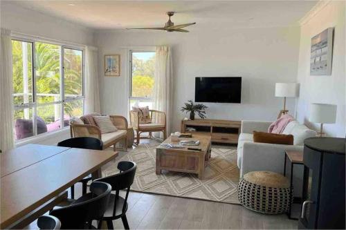 ein Wohnzimmer mit einem Sofa und einem Tisch in der Unterkunft Beachfront 4 Bedroom Home in Nepean Bay in Nepean Bay