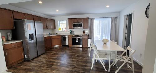 a kitchen with a table and a refrigerator at Littleton Vacation Home in Littleton