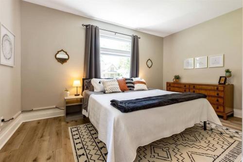 a bedroom with a large bed and a window at Modern, Rustic Farmhouse Apartment near Downtown in Mount Clemens