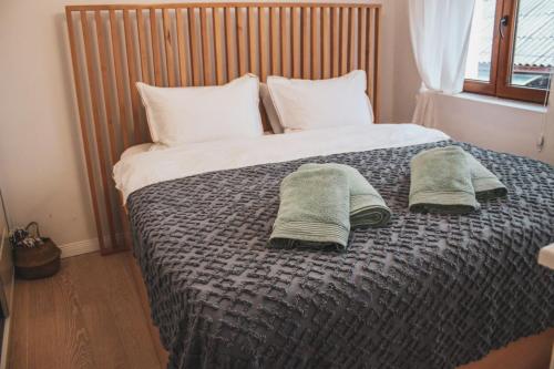 a bedroom with a bed with two towels on it at Villa Christina 2 in Ohrid