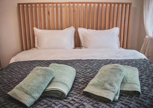 a bed with three pillows on top of it at Villa Christina 2 in Ohrid