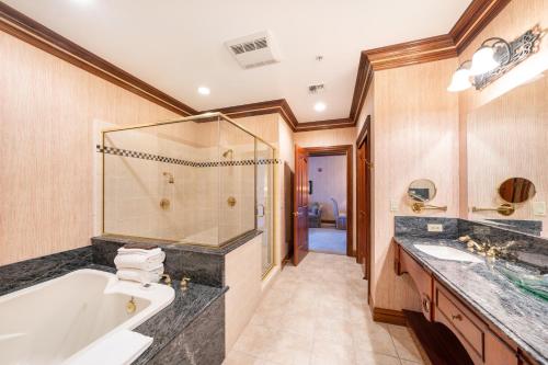 a bathroom with a tub and a sink at Stock Farm Inn in Hopland