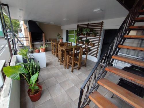 a room with a staircase and a table and chairs at Como en casa Hostel in Posadas