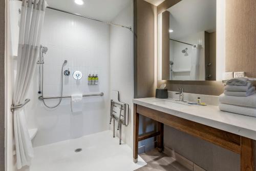 a bathroom with a shower and a sink at Staybridge Suites Grand Prairie Near Epic Central, an IHG Hotel in Grand Prairie