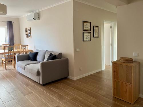 a living room with a couch and a table at Ocean Breeze in Armação de Pêra