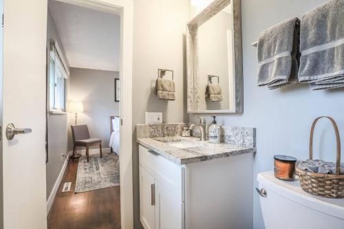 a bathroom with a sink and a mirror at NEW Modern Home w/ Beautiful Finishes! in Denver