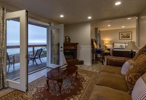 a living room with a couch and a view of the ocean at Wharf Master's Inn in Point Arena
