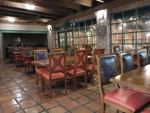 a restaurant with tables and chairs in a room at Clarion Inn in Sierra Vista