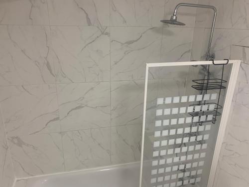 a shower with a glass door in a bathroom at 13 Clifton Court - Lovely 2 bedroom flat with patio in Finsbury Park in London