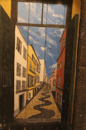 a painting of a view of a street through a window at Alexia Room in Funchal