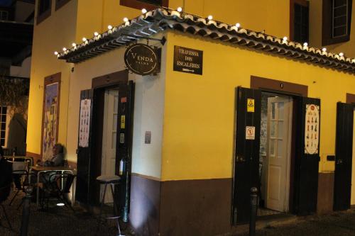 a restaurant with a sign on the side of a building at Alexia Room in Funchal