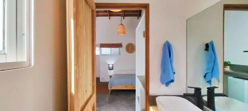 a bathroom with a sink and a mirror at Kite House Cabarete across Kite Beach in Cabarete