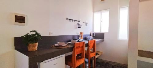 a kitchen with a counter and a table and chairs at Kite House Cabarete across Kite Beach in Cabarete