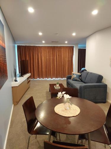 a living room with a table and a couch at Wallaroo Marina Executive Apartments in Wallaroo