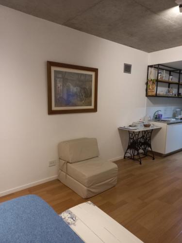 a living room with a chair and a table at Grace210 in Buenos Aires