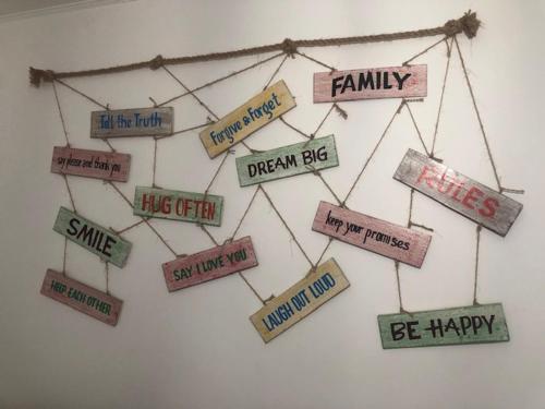 a group of signs hanging on a wall at Courtyard House - Sun, Barbecue, Beach in Sesimbra