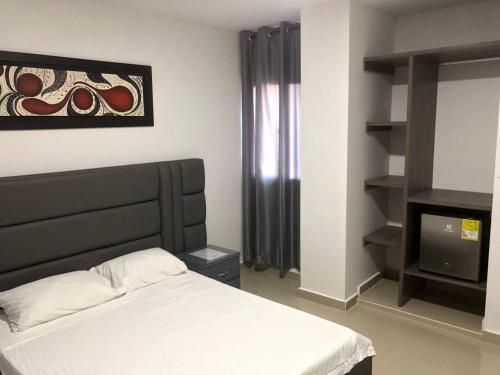 a bedroom with a bed and a tv at Hotel Don Felipe in Ríohacha