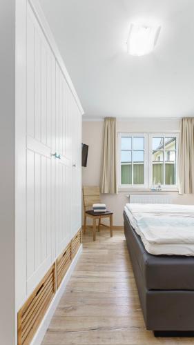Ein Bett oder Betten in einem Zimmer der Unterkunft Käpt'n Kalle Ferienwohnungen