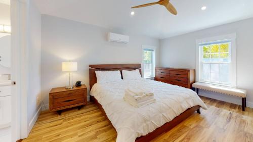 a bedroom with a large bed and a ceiling fan at Modern 2BR 2BA with King bed-Fast Wi-Fi 75 inch OLED TV in Wilmington