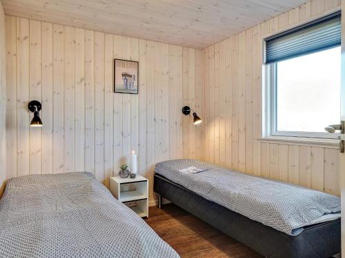 a bedroom with two beds and a window at Luxury Pool Villa in Grena - By Traum Ferienwohnungen in Grenå