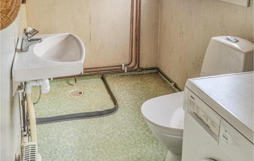 a bathroom with a sink and a toilet at Lovely Home In Degerhamn With Kitchen in Degerhamn