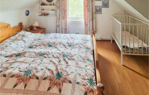 a bedroom with a bed and a crib at Lovely Home In Degerhamn With Kitchen in Degerhamn