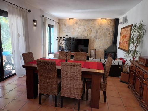 a dining room with a wooden table and chairs at Sa Bardella in Sant Joan de Labritja