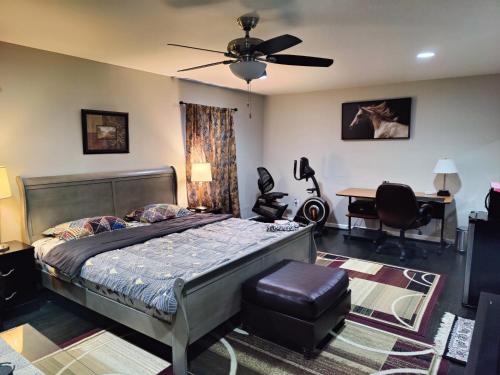 a bedroom with a bed with a ceiling fan and a desk at Luxurious stay at prime location in Herndon