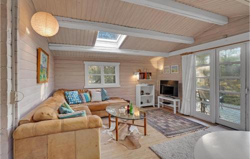 a living room with a couch and a table at Holiday Home H in Højby