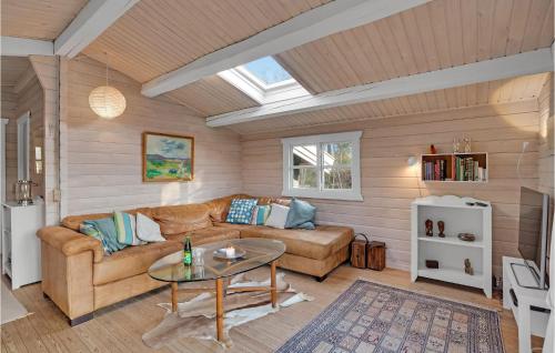 a living room with a couch and a table at Holiday Home H in Højby