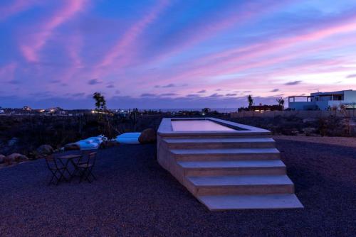 a set of steps leading to a swimming pool at sunset at Casa Santos in Todos Santos